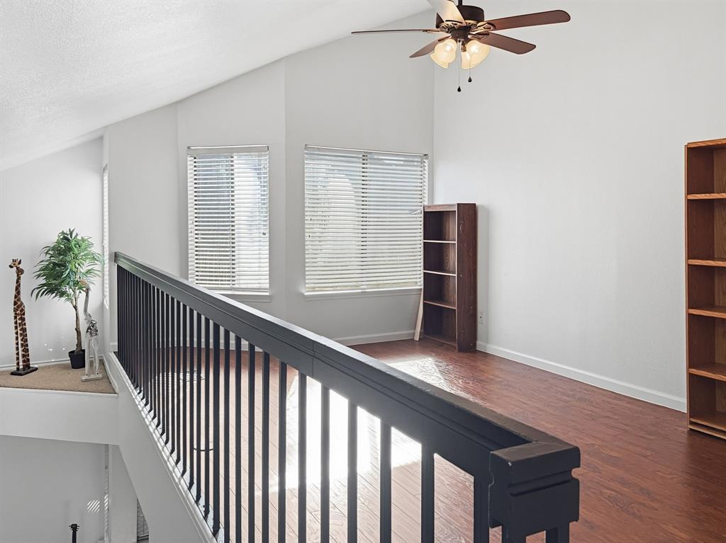 539 Ranch Trail, Unit 172 Irving, TX 75063 - Photo 23 of 40 a view of a hallway with wooden floor and a ceiling fan
