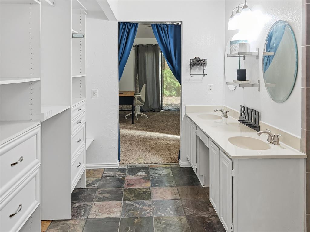 539 Ranch Trail, Unit 172 Irving, TX 75063 - Photo 29 of 40 a bathroom with a sink a toilet and a mirror