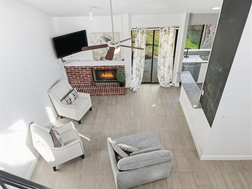 539 Ranch Trail, Unit 172 Irving, TX 75063 - Photo 4 of 40 a living room with furniture and a fireplace