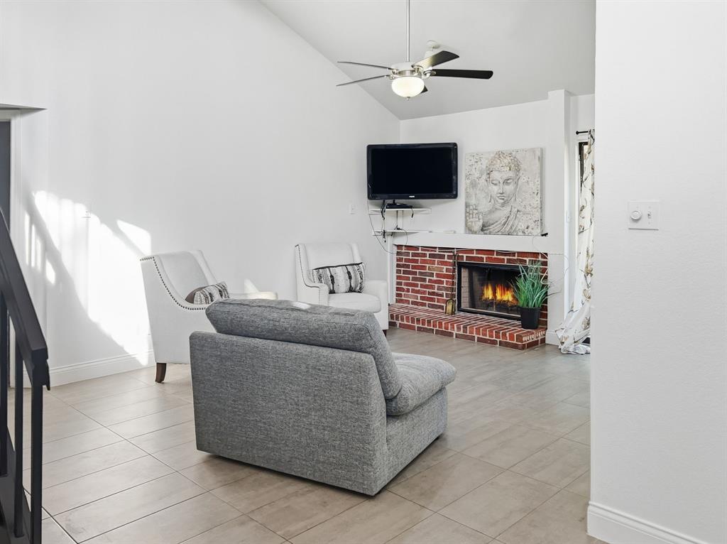 539 Ranch Trail, Unit 172 Irving, TX 75063 - Photo 7 of 40 a living room with furniture a fireplace and a flat screen tv