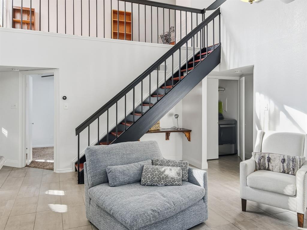 539 Ranch Trail, Unit 172 Irving, TX 75063 - Photo 9 of 40 a living room with furniture and stairs