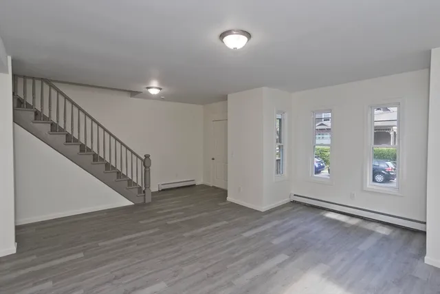 a view of an entryway with wooden floor