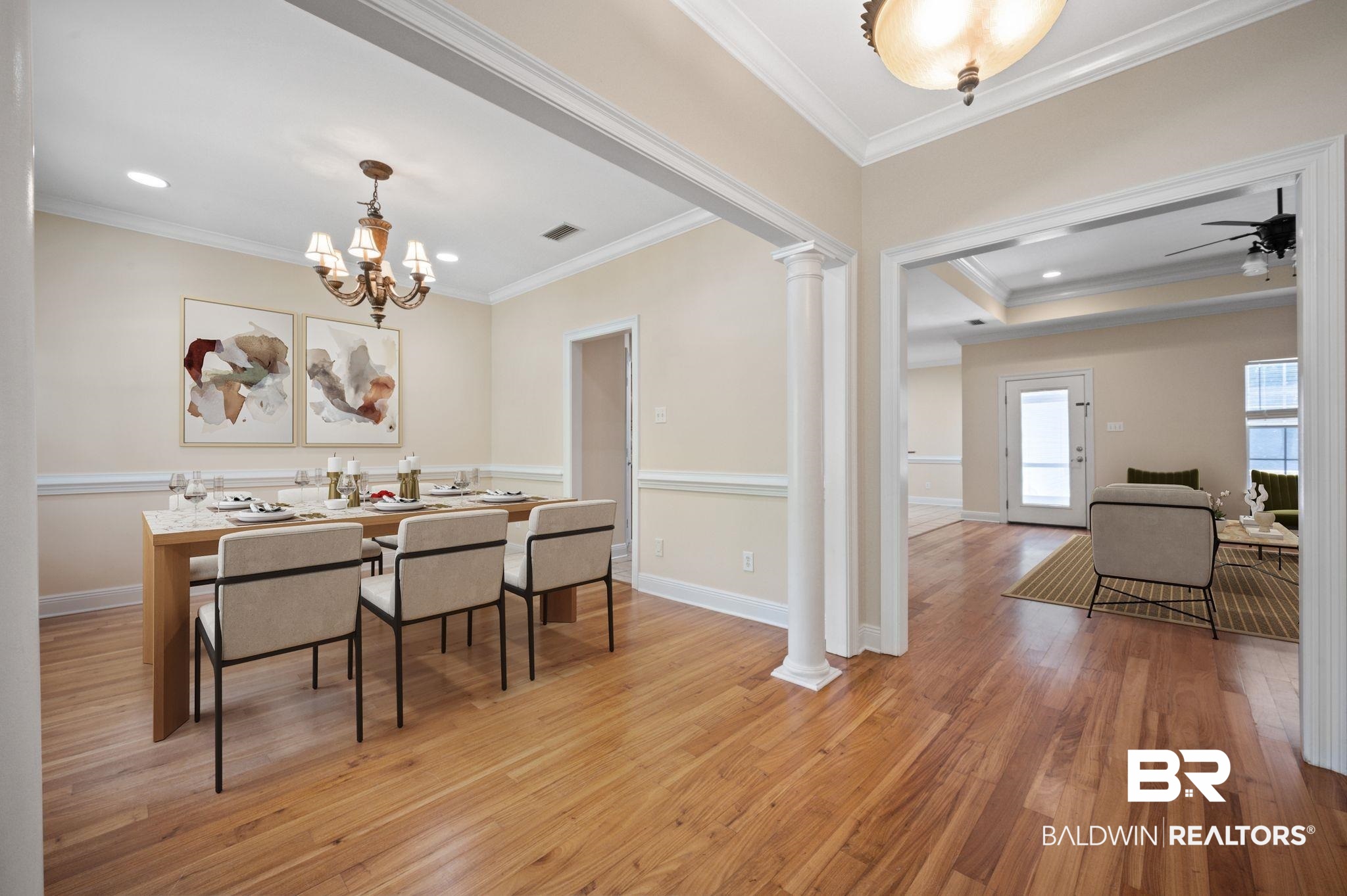 2041 Ridgeline Drive Mobile, AL 36695 - Photo 3 of 43 Dining space featuring a tray ceiling, ceiling fan with notable chandelier, ornamental molding, light hardwood / wood-style floors, and ornate columns