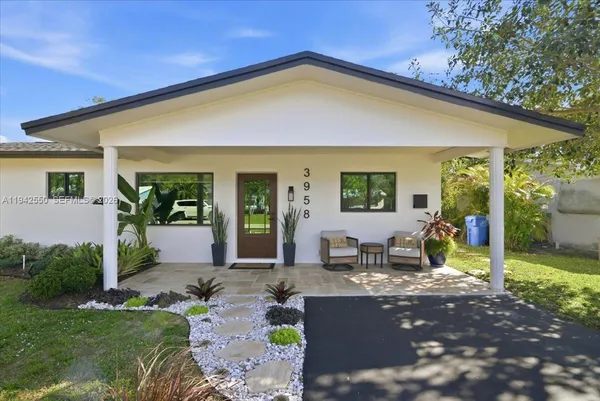 a view of a house with backyard patio and garden