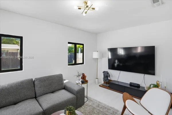 a living room with furniture a couch and a window