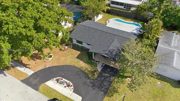 aerial view of a house with swimming pool and garden