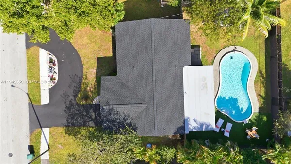 an aerial view of a house swimming pool and outdoor space