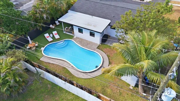 an aerial view of residential houses with outdoor space and river view