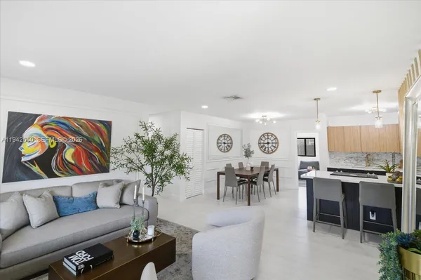 a living room with furniture and a potted plant