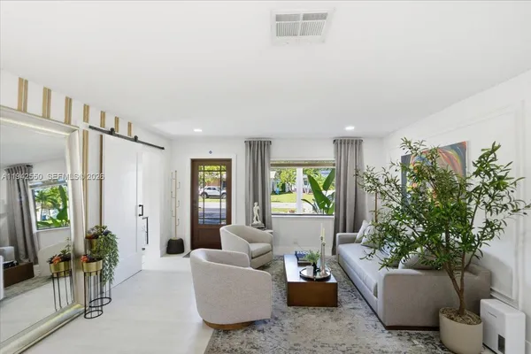 a kitchen with stainless steel appliances a table chairs and a refrigerator