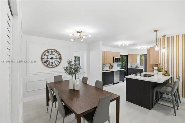 a kitchen that has a lot of cabinets a sink and a stove in it