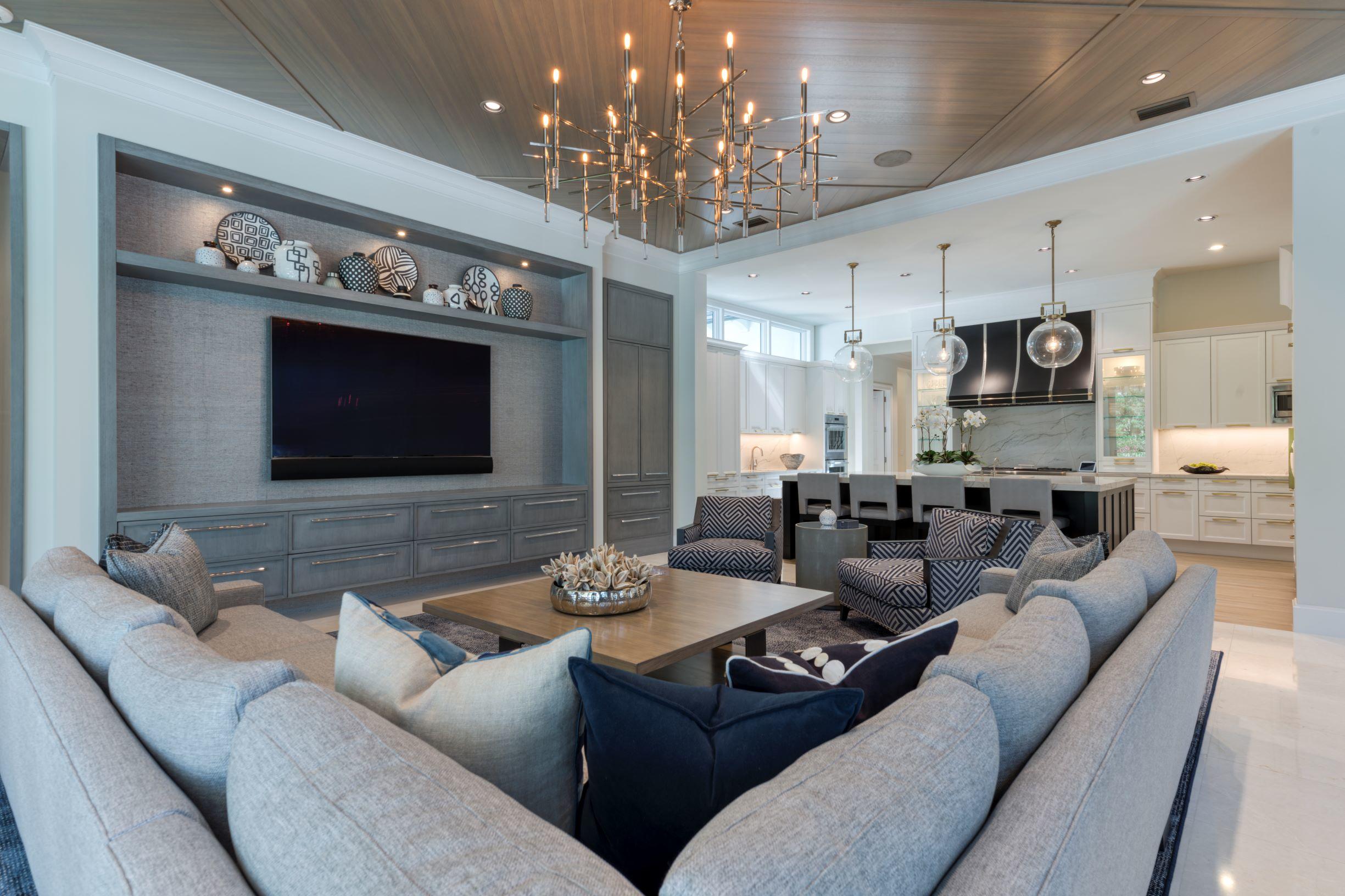 111 Clipper Lane Jupiter, FL 33477 - Photo 14 of 59 a living room with furniture a chandelier and a flat screen tv