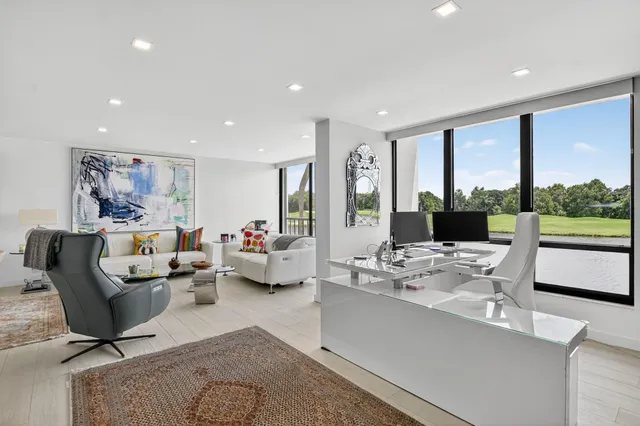 a living room with furniture a couch and a kitchen view