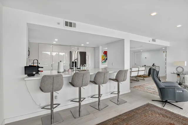 a kitchen with stainless steel appliances a refrigerator stove and microwave