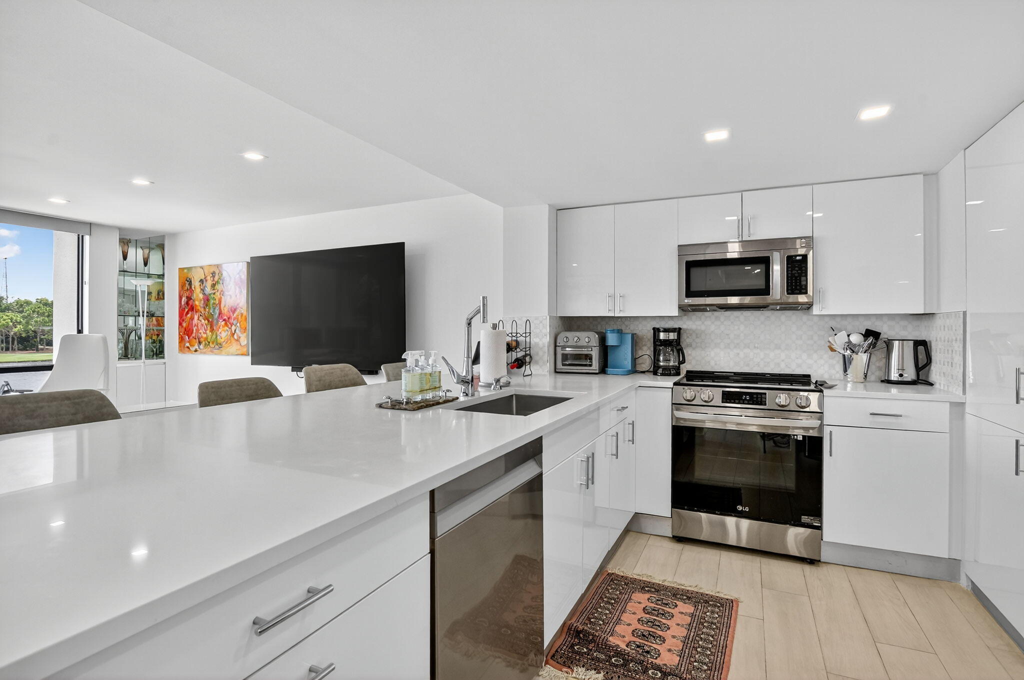 7768 Lakeside Boulevard, Unit 526 Boca Raton, FL 33434 - Photo 16 of 56 a kitchen with stainless steel appliances a stove microwave and sink