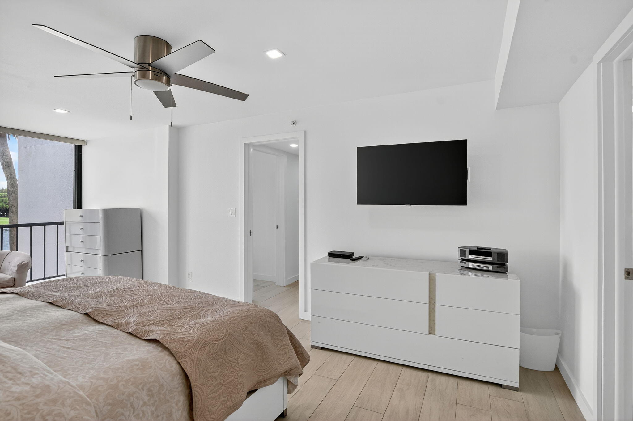 7768 Lakeside Boulevard, Unit 526 Boca Raton, FL 33434 - Photo 20 of 56 a bedroom with a bed and a flat screen tv