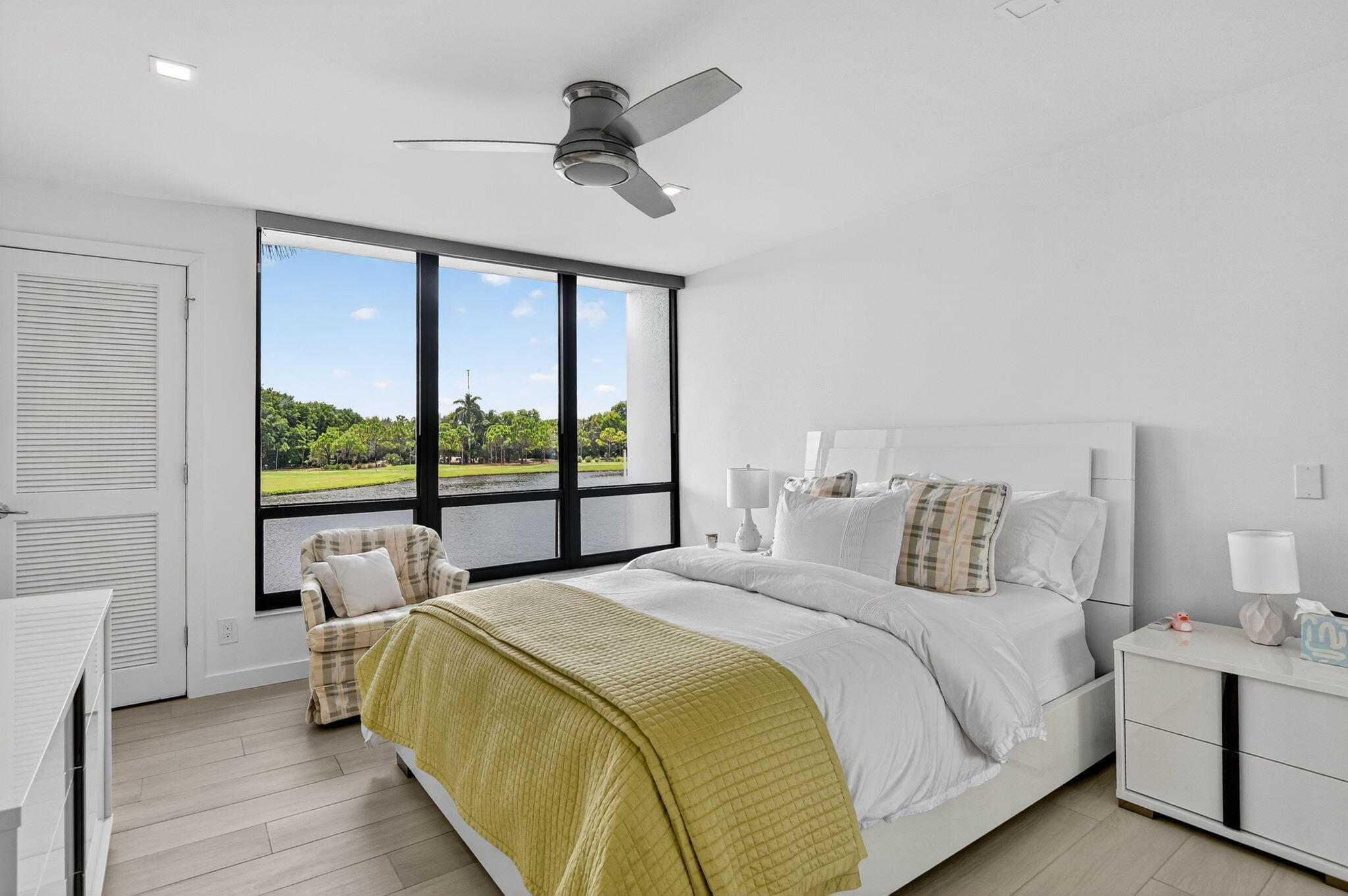 7768 Lakeside Boulevard, Unit 526 Boca Raton, FL 33434 - Photo 2 of 56 a bedroom with a large bed and a large window