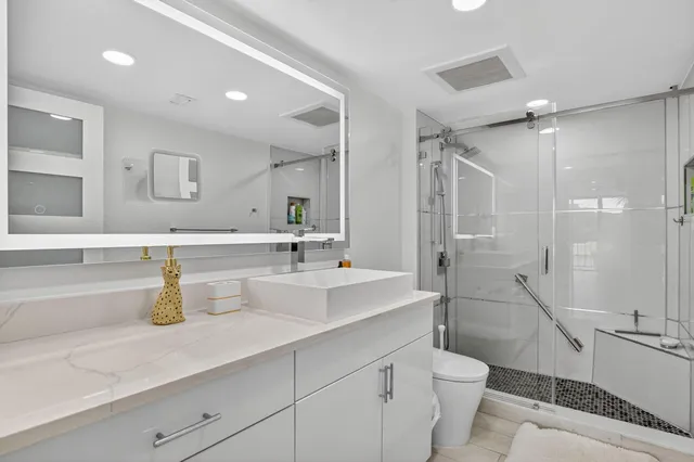 a bedroom with a large bed and a large window