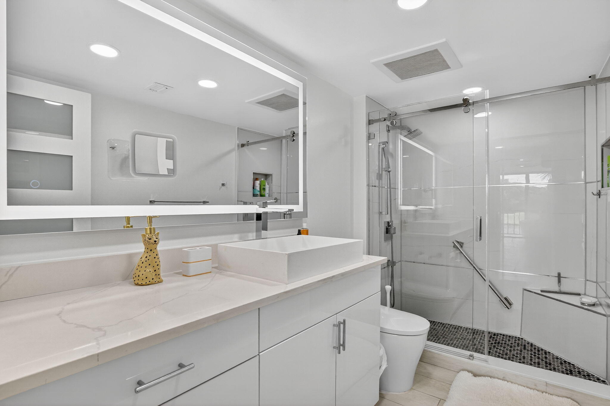 7768 Lakeside Boulevard, Unit 526 Boca Raton, FL 33434 - Photo 21 of 56 a bathroom with a sink a toilet and shower