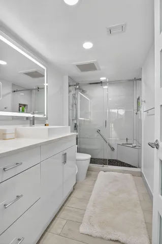 a bathroom with a sink toilet and shower