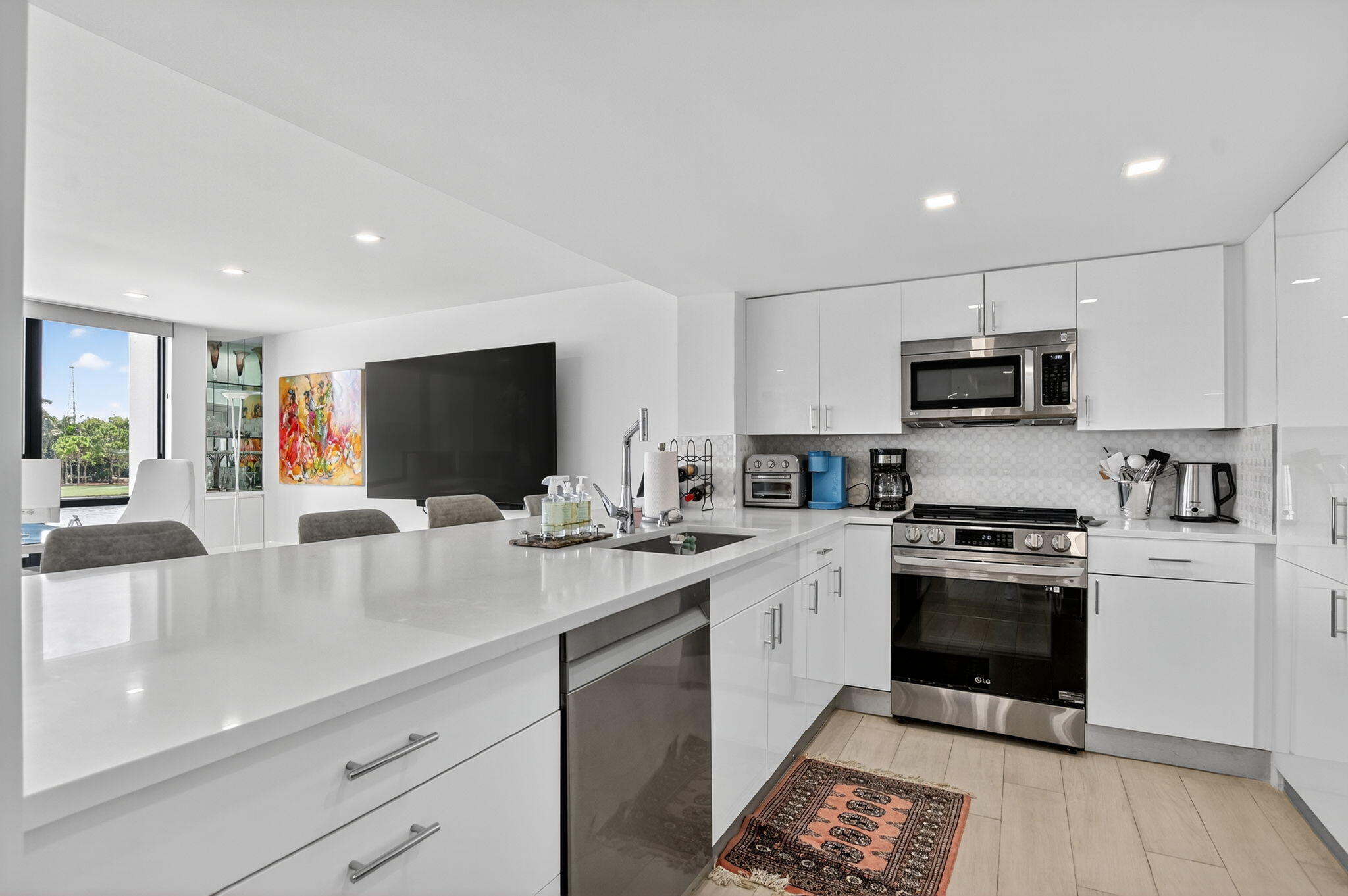 7768 Lakeside Boulevard, Unit 526 Boca Raton, FL 33434 - Photo 4 of 56 a kitchen with a sink stainless steel appliances and cabinets