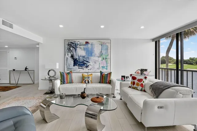 a living room with furniture kitchen view and a table