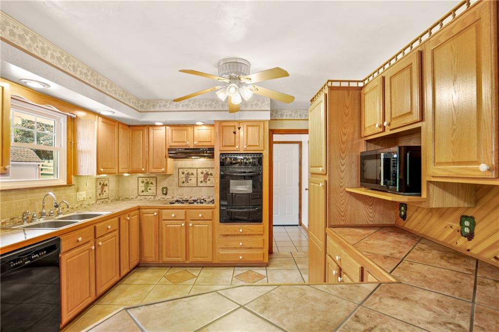 678 West Main Street Somerset, PA 15501 - Photo 12 of 38 a large kitchen with stainless steel appliances granite countertop a refrigerator and a sink