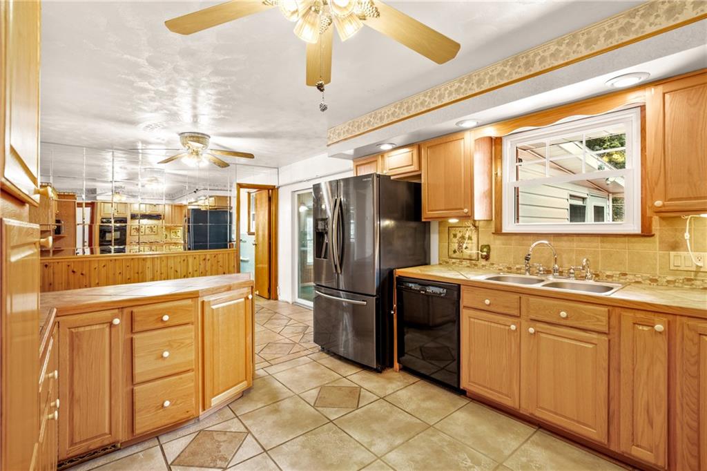 678 West Main Street Somerset, PA 15501 - Photo 13 of 38 a kitchen with stainless steel appliances granite countertop a refrigerator and a stove top oven