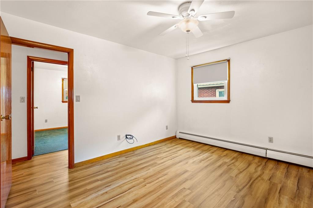 678 West Main Street Somerset, PA 15501 - Photo 18 of 38 an empty room with wooden floor chandelier fan and windows