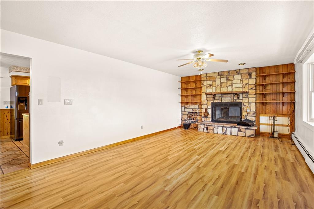 678 West Main Street Somerset, PA 15501 - Photo 4 of 38 wooden floor in an empty room with a fireplace