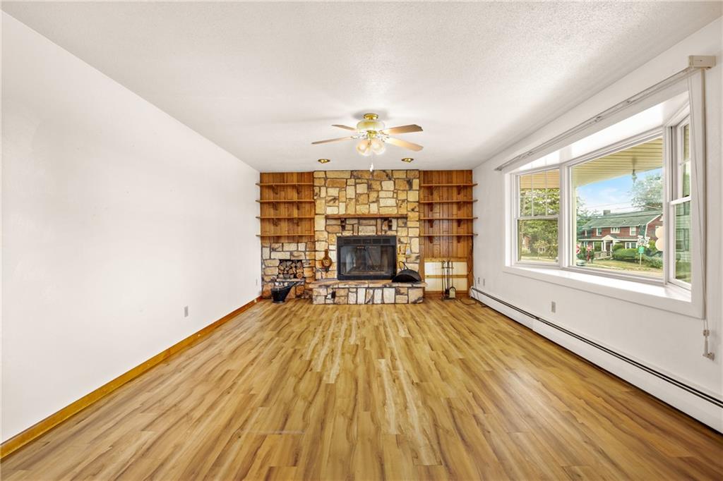 678 West Main Street Somerset, PA 15501 - Photo 5 of 38 an empty room with wooden floor chandelier fan and windows