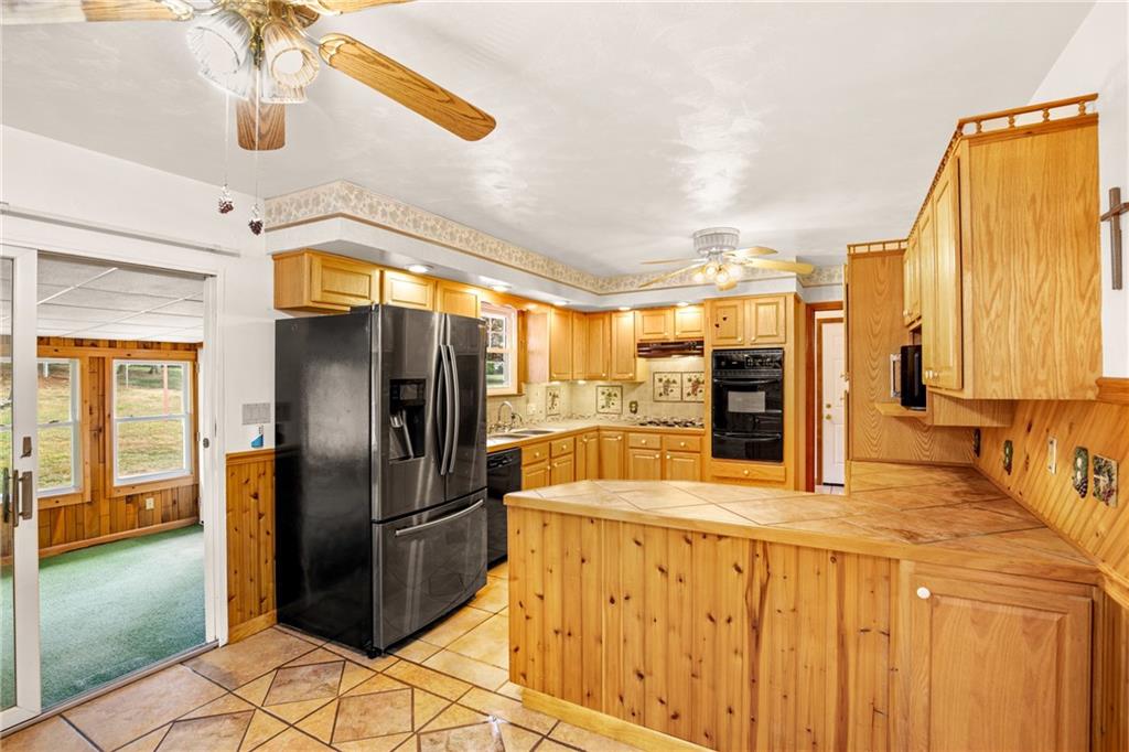 678 West Main Street Somerset, PA 15501 - Photo 8 of 38 a kitchen with stainless steel appliances kitchen island granite countertop a refrigerator and a sink