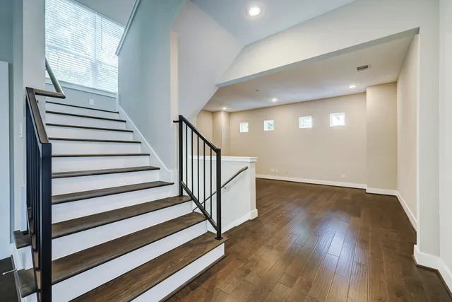 a view of entryway and hall with wooden floor