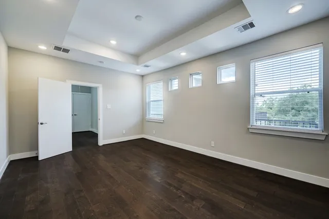 a bathroom with a white tub shower and sink