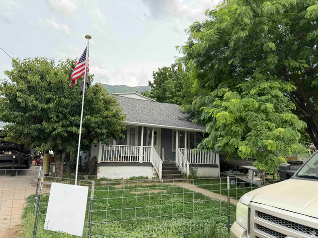 1225 South Main Street Mapleton, UT 84664 - Photo 9 of 9 Charming single-story residence with a covered front porch featuring white railings