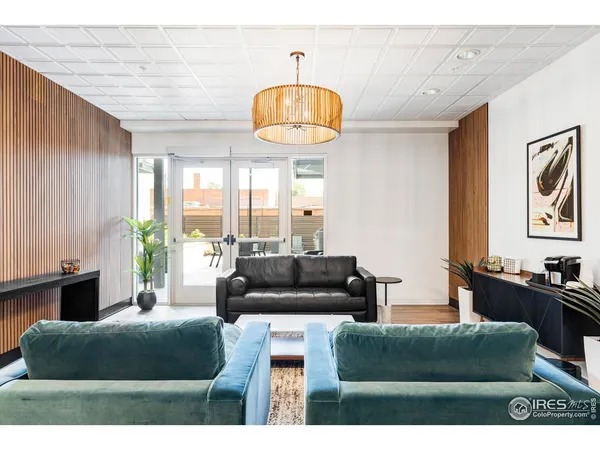 a living room with furniture a chandelier and a fireplace