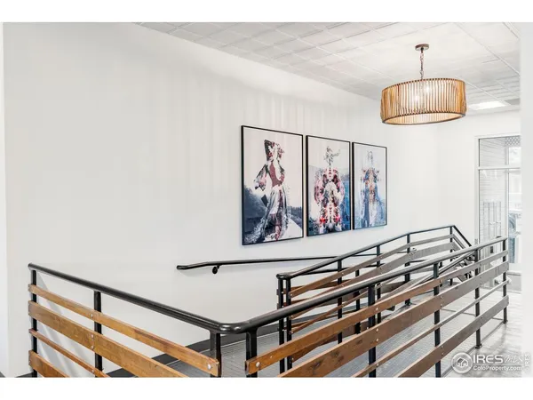 a view of a room with paintings on the wall