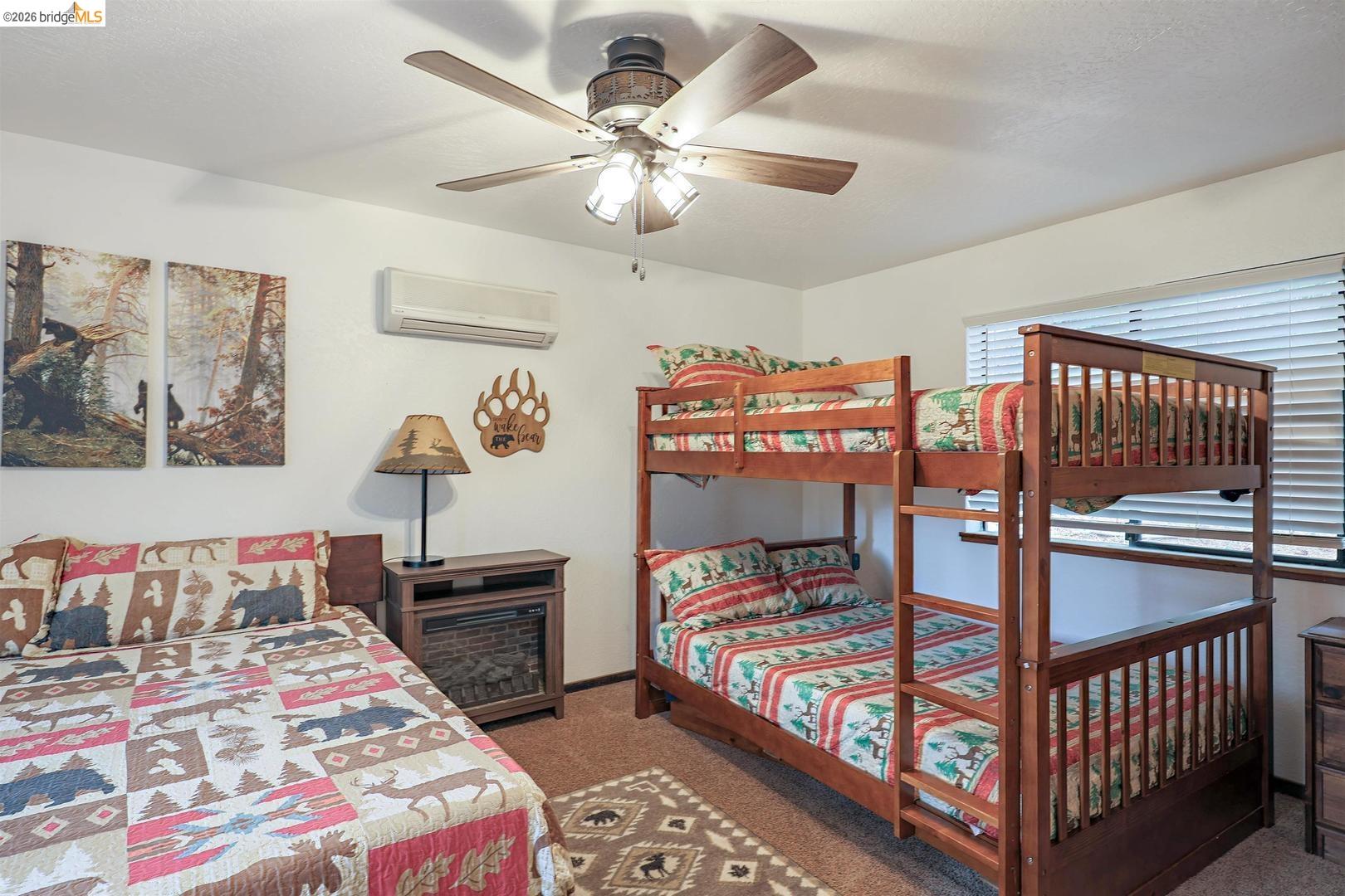 26600 Inyo Drive Cold Springs, CA 95335 - Photo 17 of 38 a bedroom with a bed and a chandelier
