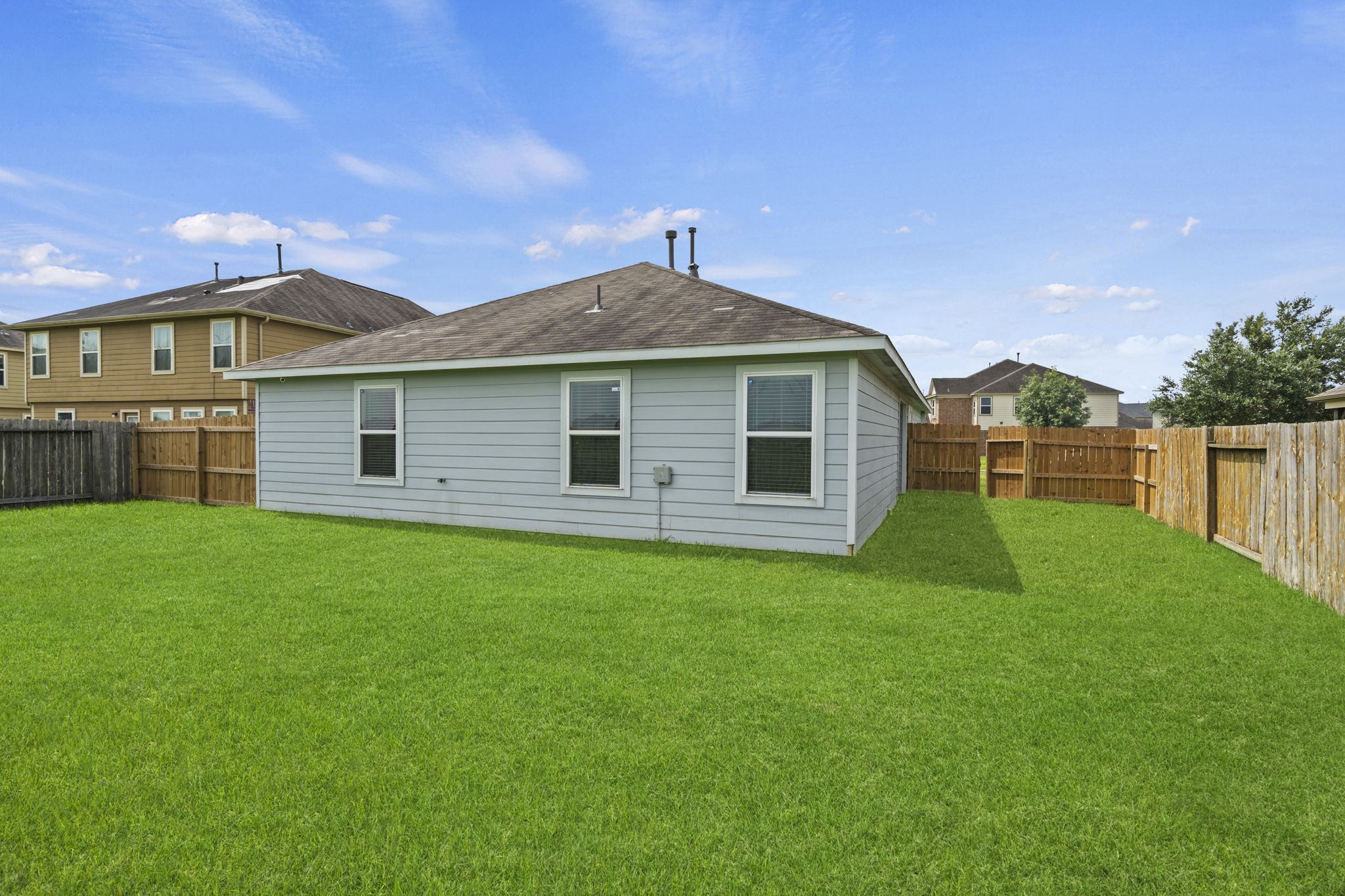 2110 Red Cedar Trail Rosenberg, TX 77471 - Photo 16 of 20 Clean siding, fitted window treatments, and wide-open sky exposure complete this neat, move-in-ready property exterior.