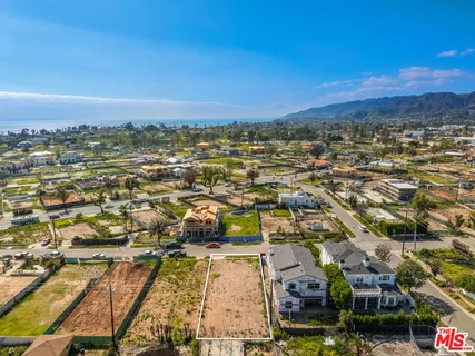 an aerial view of residential houses with city view