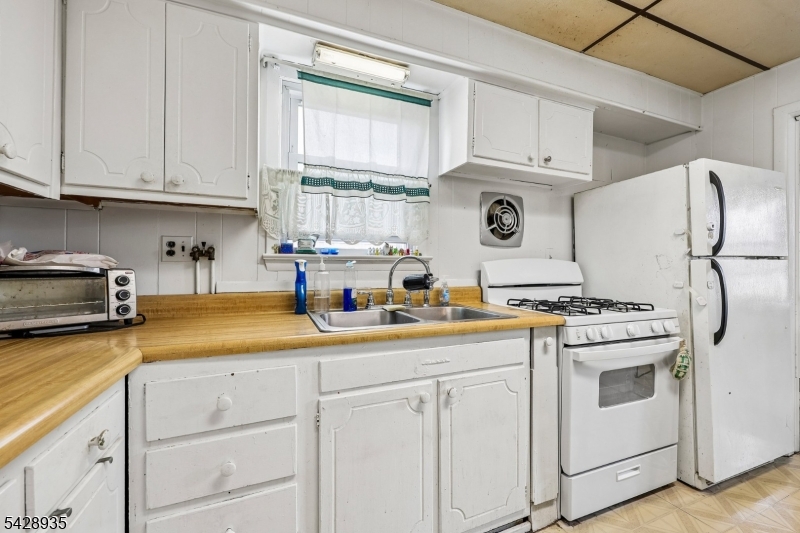 50 Preston Street Ridgefield Park, NJ 07660 - Photo 20 of 41 a kitchen with granite countertop white cabinets and white appliances