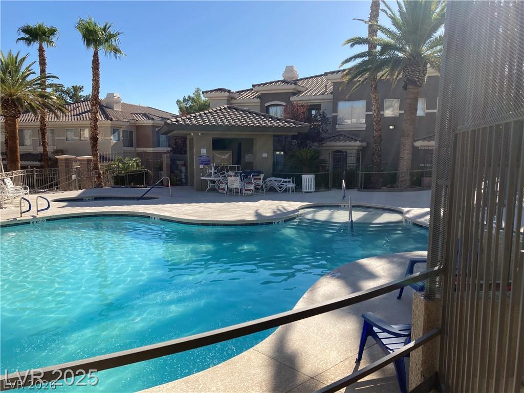 9050 West Warm Springs Road, Unit 1027 Las Vegas, NV 89148 - Photo 37 of 44 Lush landscaping and mature palm trees surround this inviting community pool and spa.