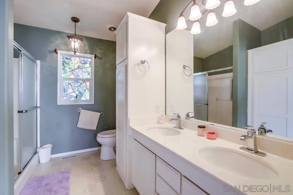 8301 Mission Gorge Road, Unit 248 Santee, CA 92071 - Photo 13 of 24 a bathroom with a sink a toilet a shower and a mirror
