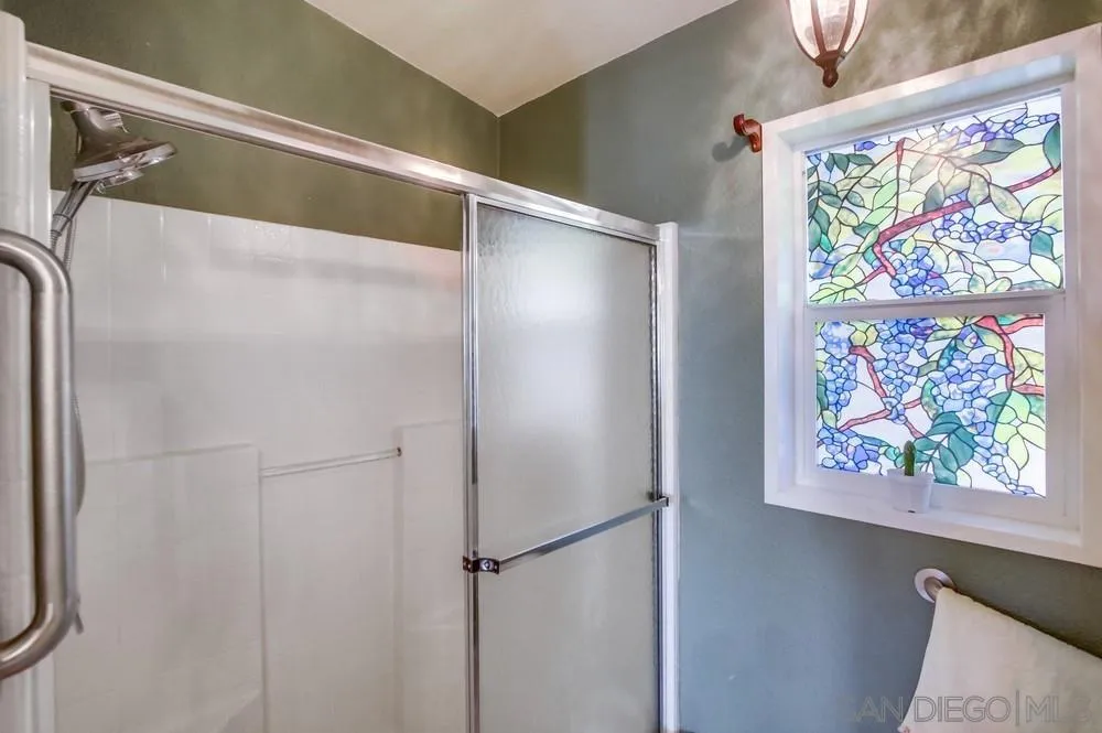 8301 Mission Gorge Road, Unit 248 Santee, CA 92071 - Photo 14 of 24 a bathroom with a glass shower door and a window