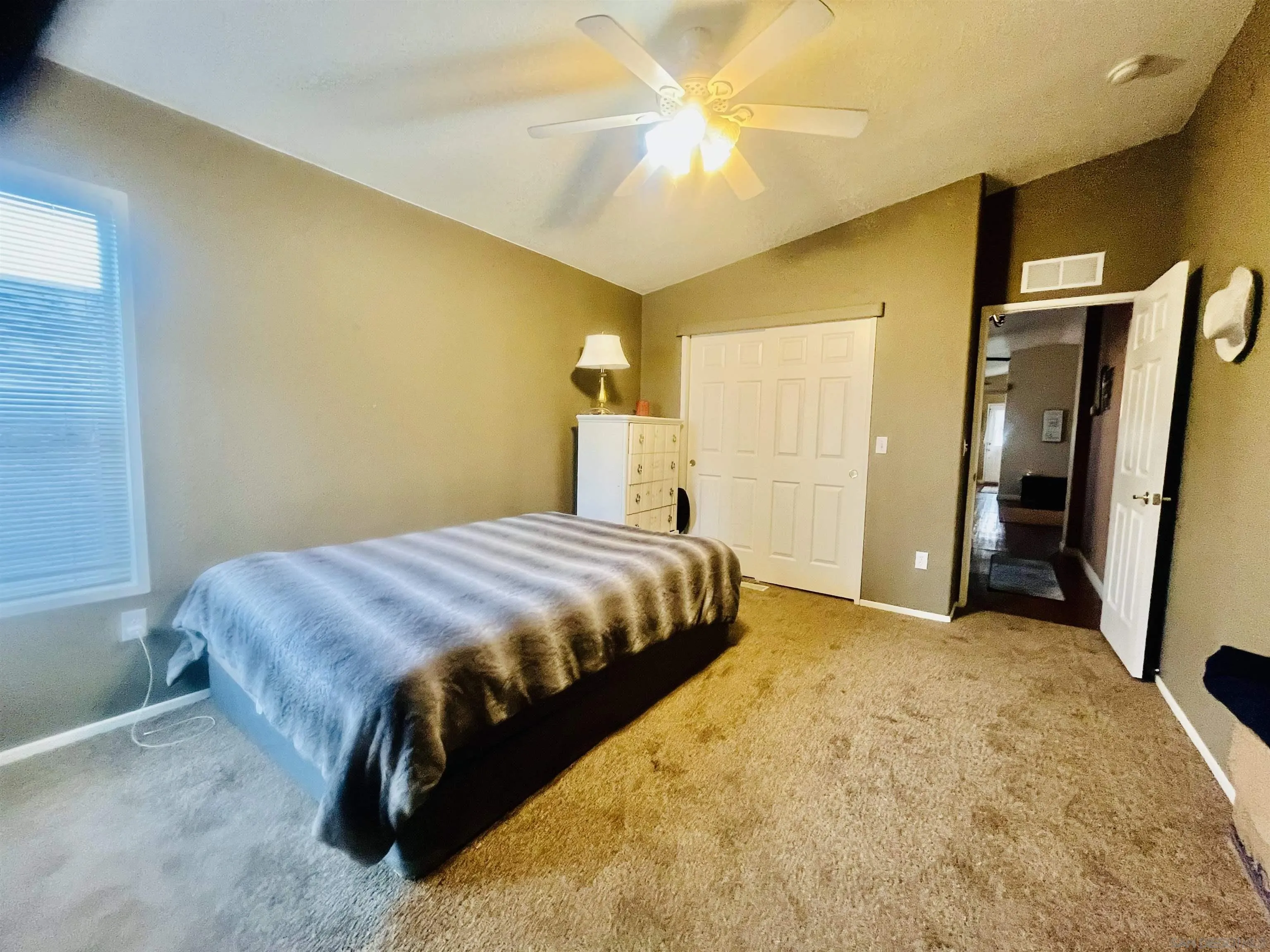 8301 Mission Gorge Road, Unit 248 Santee, CA 92071 - Photo 19 of 24 a bedroom with a bed and a chandelier