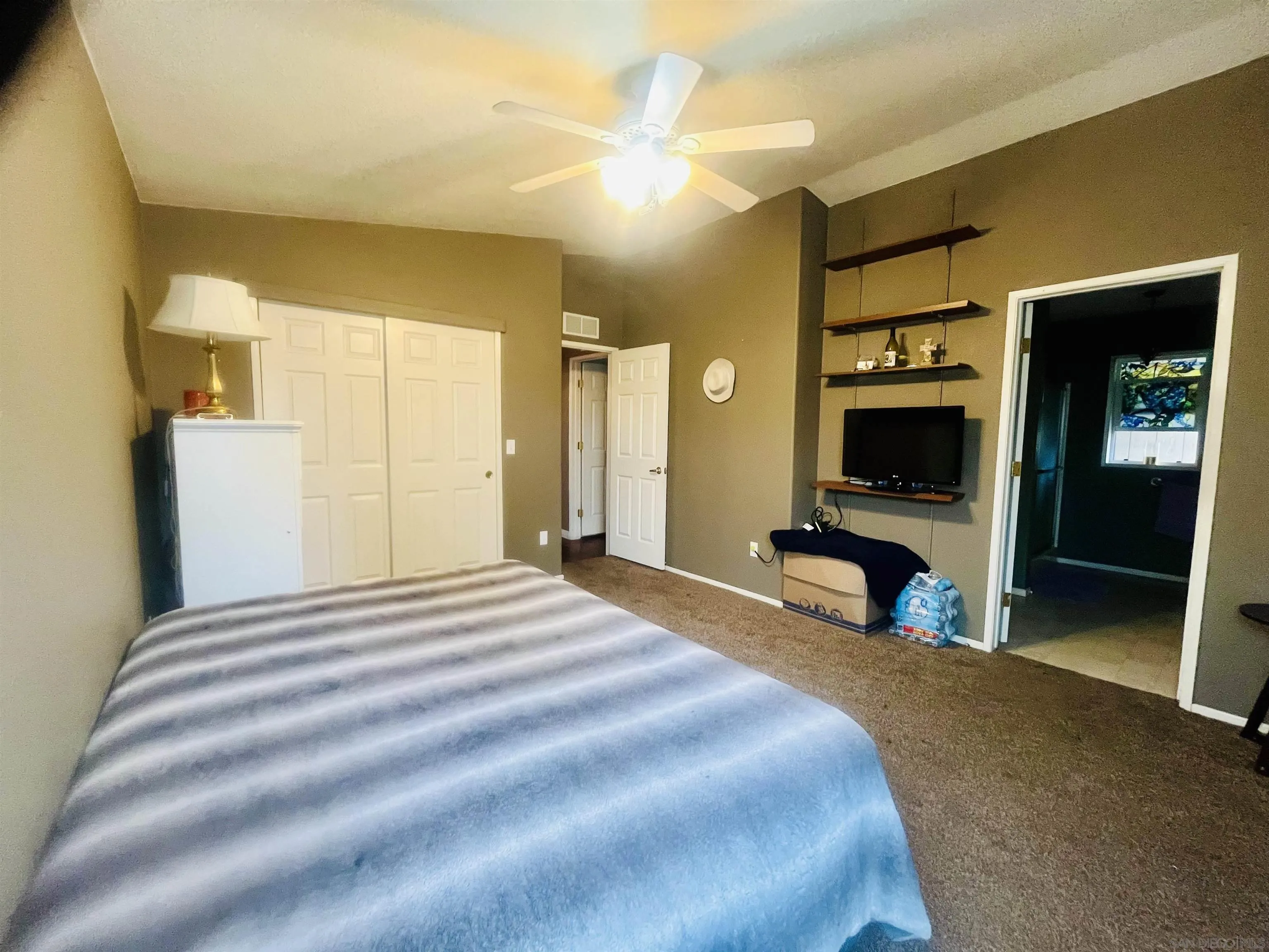 8301 Mission Gorge Road, Unit 248 Santee, CA 92071 - Photo 20 of 24 a bedroom with a bed and a television
