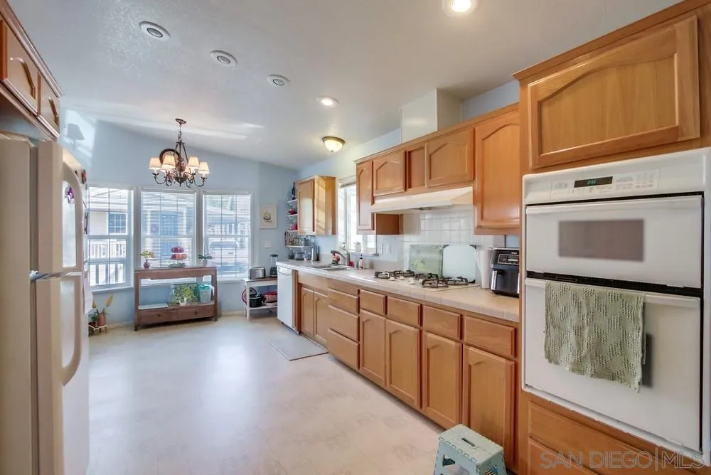 8301 Mission Gorge Road, Unit 248 Santee, CA 92071 - Photo 7 of 24 a kitchen with stainless steel appliances a stove a sink and a refrigerator