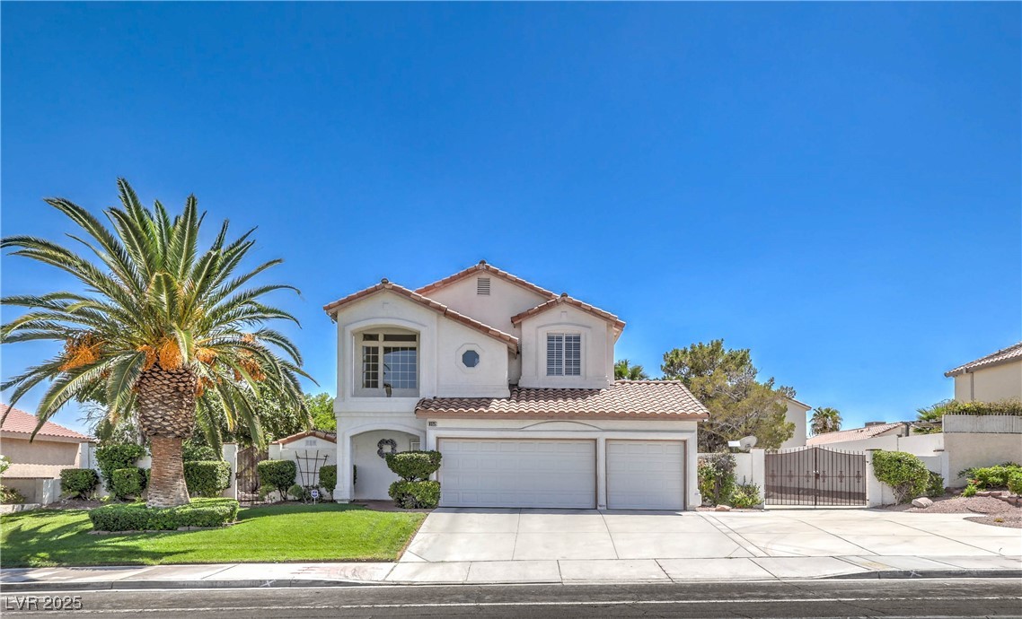 Mediterranean / spanish house with driveway, a gate, a tile roof, stucco siding, and a garage