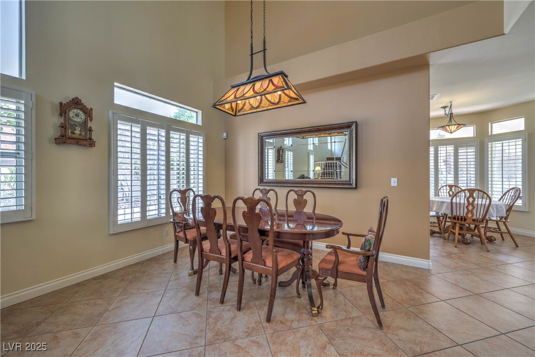 8325 Alta Drive Las Vegas, NV 89145 - Photo 13 of 31 Dining room featuring light tile patterned floors and healthy amount of natural light