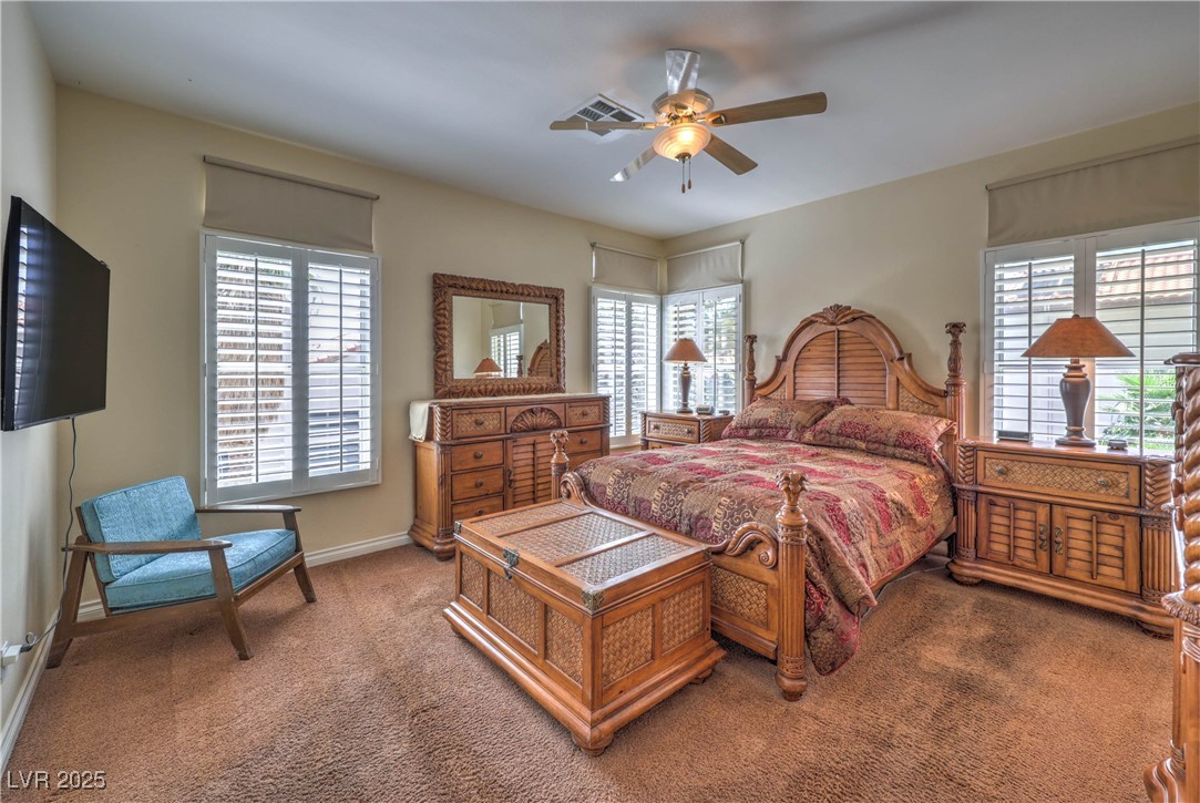 8325 Alta Drive Las Vegas, NV 89145 - Photo 17 of 31 Bedroom with multiple windows, carpet floors, and ceiling fan